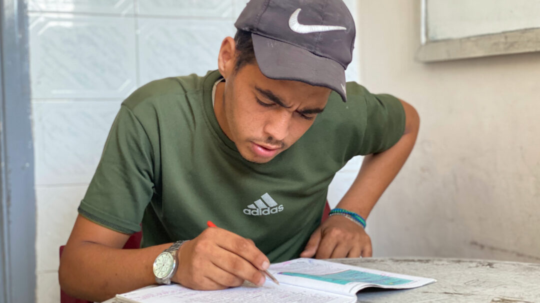 Tawfiq Abu Dallal studying for his final exams in Gaza City (MEE/Ahmed Dremly)